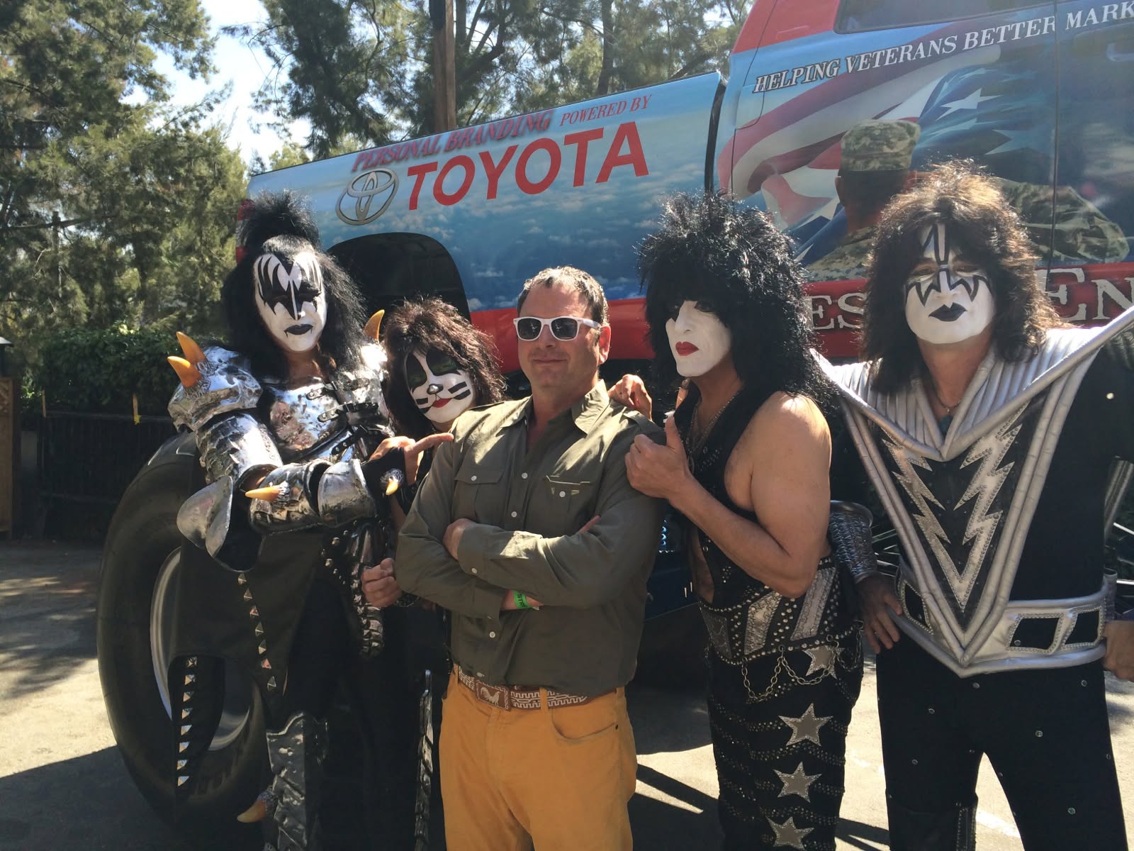 Steve in sunglasses surrounded by rock-and-roll costumes
