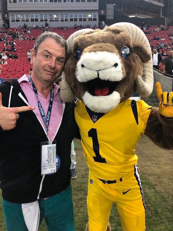 Steve posing with a football mascot